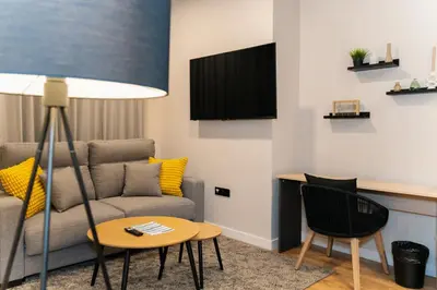 a living room with a couch and a table at Dorm4You Arena 2 in Valencia
