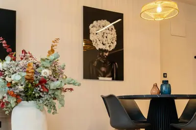 a room with a table and a vase of flowers at Dorm4You Arena 2 in Valencia