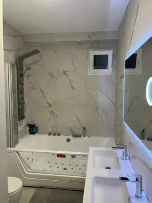 a bathroom with a tub and two sinks and a toilet at Modern apartment in heart of city in Valencia