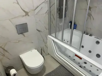 a bathroom with a white toilet and a shower at Modern apartment in heart of city in Valencia