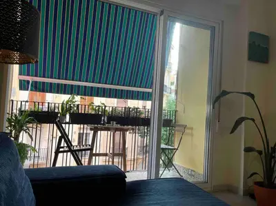 a living room with a sliding glass door to a balcony at Modern apartment in heart of city in Valencia