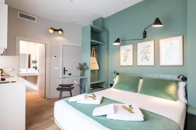 a bedroom with a bed with two towels on it at Moontels Mercado de Ruzafa in Valencia