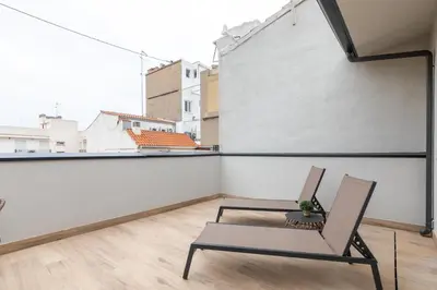 an apartment balcony with a chair and a table at Moontels Mercado de Ruzafa in Valencia