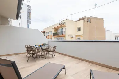 a balcony with chairs and a table on a building at Moontels Mercado de Ruzafa in Valencia