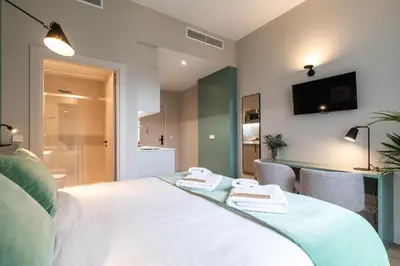a bedroom with a bed with two towels on it at Moontels Mercado de Ruzafa in Valencia