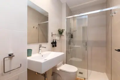 a bathroom with a sink and a toilet and a shower at Moontels Mercado de Ruzafa in Valencia