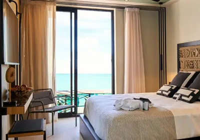a bedroom with a bed and a view of the ocean at ESTIMAR Marina Farnals in Puebla de Farnals