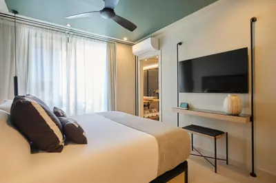 a bedroom with a large bed and a flat screen tv at ESTIMAR Marina Farnals in Puebla de Farnals