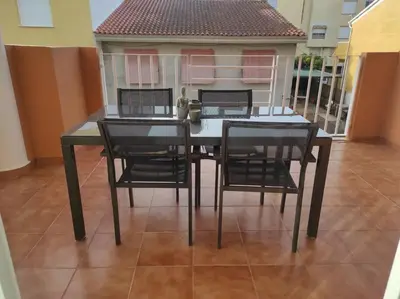 a dining room table and chairs on a balcony at Apartamento Playa Xilxes in Xilxes