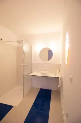 a white bathroom with a sink and a shower at Marino by Concept in Valencia