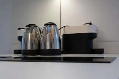 two coffee pots sitting on top of a stove at Marino by Concept in Valencia