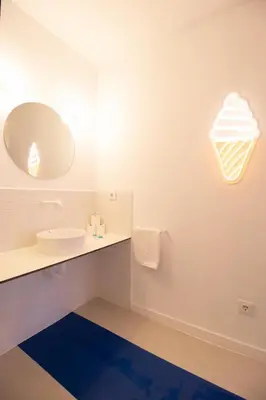 a bathroom with a white sink and a blue rug at Marino by Concept in Valencia