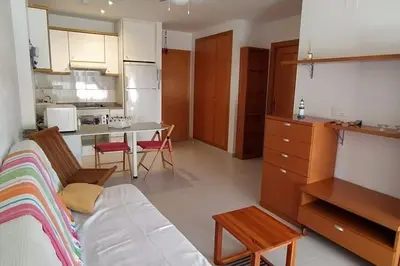 a living room with a couch and a kitchen at Precioso apartamento en Canet d,en Berenger in Canet de Berenguer