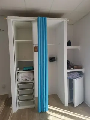 a closet with a blue curtain in a room at Relais Pollo Loco in Valencia