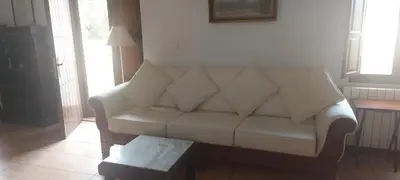 a living room with a white couch and a table at El Pino B & B, Chera in Valencia
