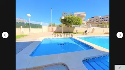 a swimming pool in the middle of a building at CANET PLAYA MAGNIFICO APTO FAMILIAR con PISCINA y GARAJE in Canet de Berenguer