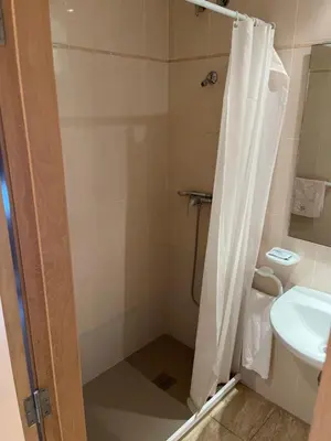 a bathroom with a shower with a toilet and a sink at Hostal Restaurant El Poligono in Valencia