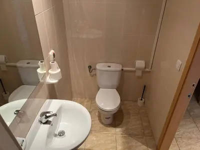 a bathroom with a toilet and a sink at Hostal Restaurant El Poligono in Valencia