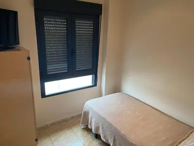 a bedroom with a window with a bed and a television at Hostal Restaurant El Poligono in Valencia