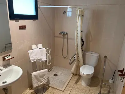 a bathroom with a shower and a toilet and a sink at Hostal Restaurant El Poligono in Valencia
