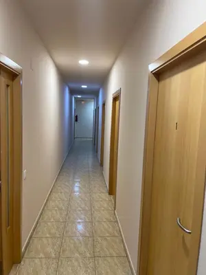 a hallway with doors and a tile floor at Hostal Restaurant El Poligono in Valencia