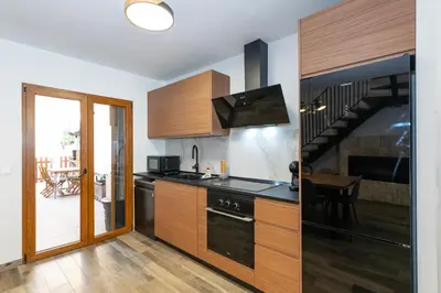 a kitchen with a sink and a stove top oven at Casa Rural Sarsalet in Chella