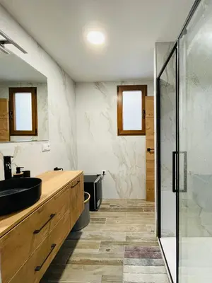 a bathroom with a sink and a glass shower at Casa Rural Sarsalet in Chella