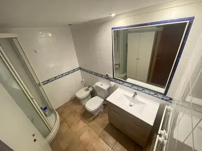 a bathroom with a toilet and a sink and a mirror at Apartamento Rey I in Valencia