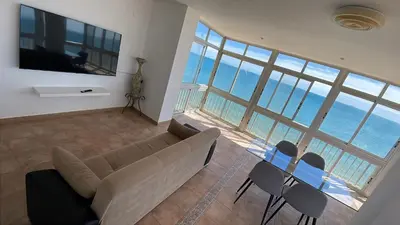 a living room with a couch and a table and chairs at Apartamento Rey I in Valencia