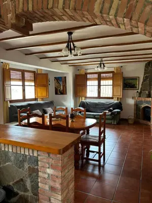 a living room with a table and a couch at RuralRusticHome in Altura