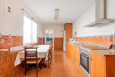 a kitchen with a table and a dining room at Casa con terraza en Sierra de Espadán in Vall de Uixó