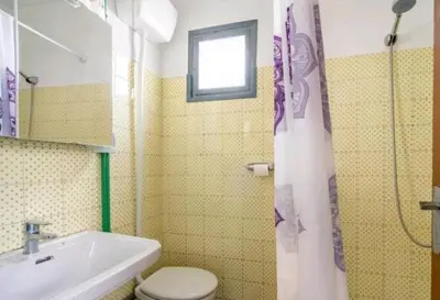 a bathroom with a toilet and a sink and a shower at Casa con terraza en Sierra de Espadán in Vall de Uixó