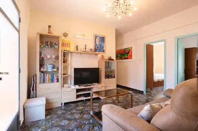 a living room with a couch and a television at Casa con terraza en Sierra de Espadán in Vall de Uixó