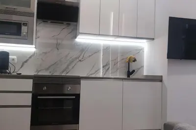 a kitchen with white cabinets and marble counter tops at Apartamento 4 habitaciones 2 baños Ciudad de las Ciencias VT-55209-V in Valencia