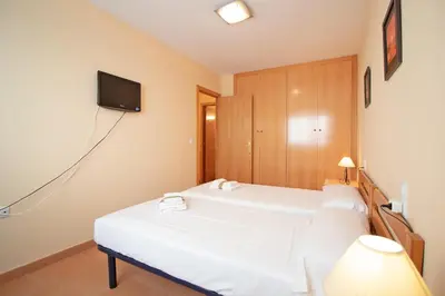 a bathroom with a washing machine and a toilet at Global Vacacional, Práctico apartamento en la playa de Canet in Canet de Berenguer