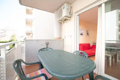 a bedroom with two beds with white sheets at Global Vacacional, Práctico apartamento en la playa de Canet in Canet de Berenguer