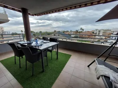 a table and chairs on a balcony with a view at Vistas al mar en Canet Playa WIFI in Canet de Berenguer