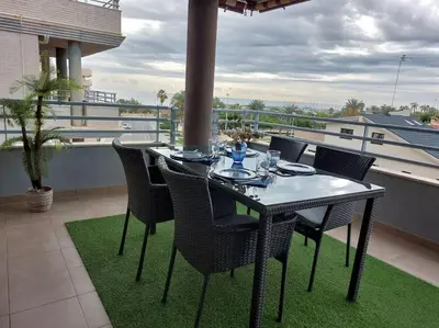 a dining table and chairs on a balcony at Vistas al mar en Canet Playa WIFI in Canet de Berenguer