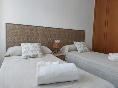 two beds sitting next to each other in a bedroom at Vistas al mar en Canet Playa WIFI in Canet de Berenguer