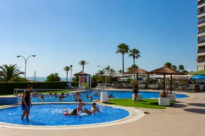 a group of people in a pool at a resort at Cullera Beach Apartment Espacio in Cullera