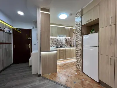 a kitchen with wooden cabinets and a white refrigerator at Peset 69 in Valencia