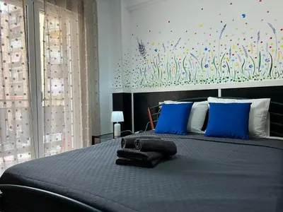 a bedroom with a large bed with blue pillows at Peset 69 in Valencia