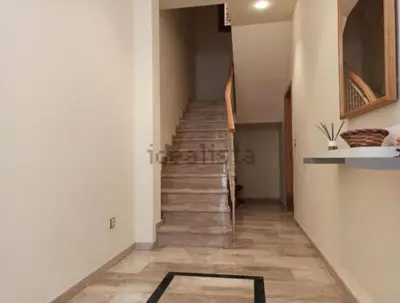 a hallway with stairs and a rug on the floor at Vivienda Planta Baja in Algemesí
