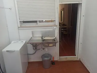 a small bathroom with a sink and a window at Vivienda Planta Baja in Algemesí