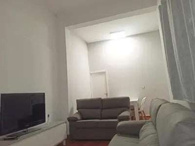 a living room with a couch and a television at Vivienda Planta Baja in Algemesí