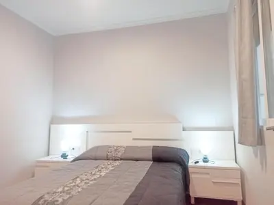 a bedroom with a large bed and two night stands at Vivienda Planta Baja in Algemesí