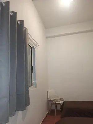 a bedroom with a bed and a window and a chair at Vivienda Planta Baja in Algemesí