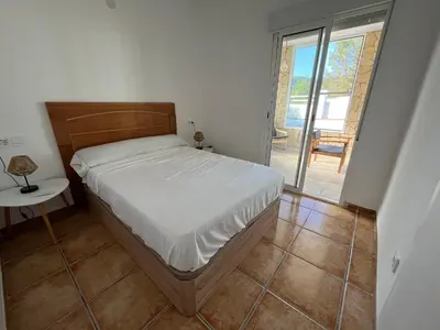 a bedroom with a bed and a table and a window at Casa de campo Ismael in Siete Aguas