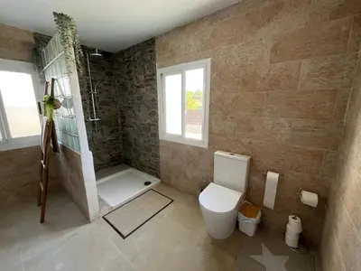 a bathroom with a shower and a toilet in it at Casa de campo Ismael in Siete Aguas