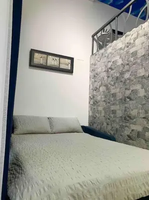 a bedroom with a bed and a stone wall at Fantastic Loft with an exquisite design in Valencia